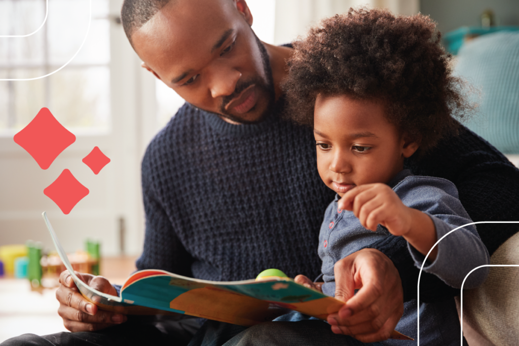 a dad reads to his child while they sit on his lap