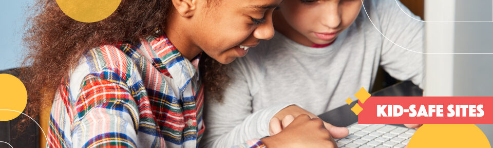 Two children type on a computer keyboard together