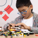 Young boy concentrates on building a spectacular lego creation