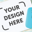 a computer mouse on a blank mouse pad that says "your design here"