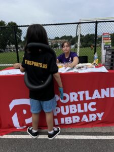 Eliza brings her work to the community and shares library resources at community events.